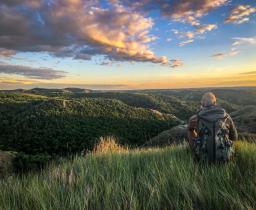 Great Outdoors Adventure, photo with hiker overlooking North Dakota badlands by Sierrah Fischer