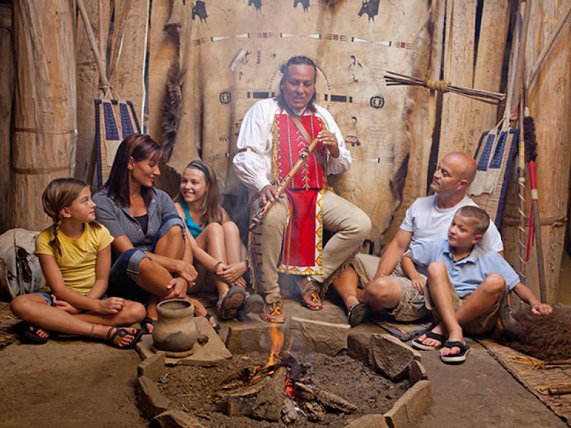 Family listening to Native American flute player